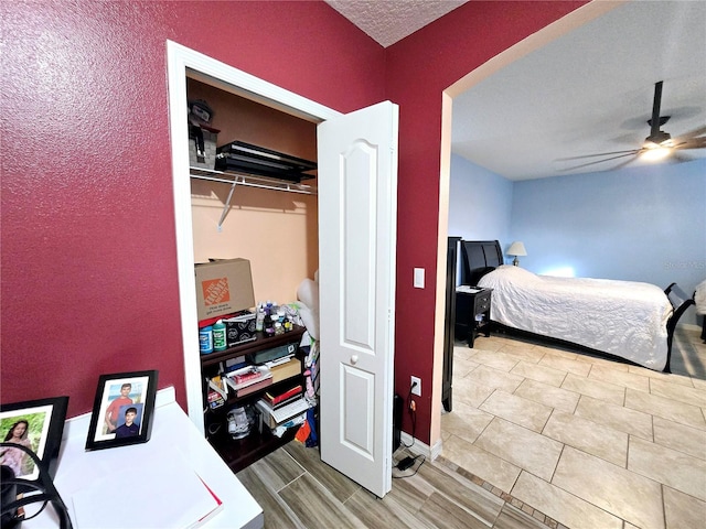 bedroom featuring a textured ceiling and ceiling fan