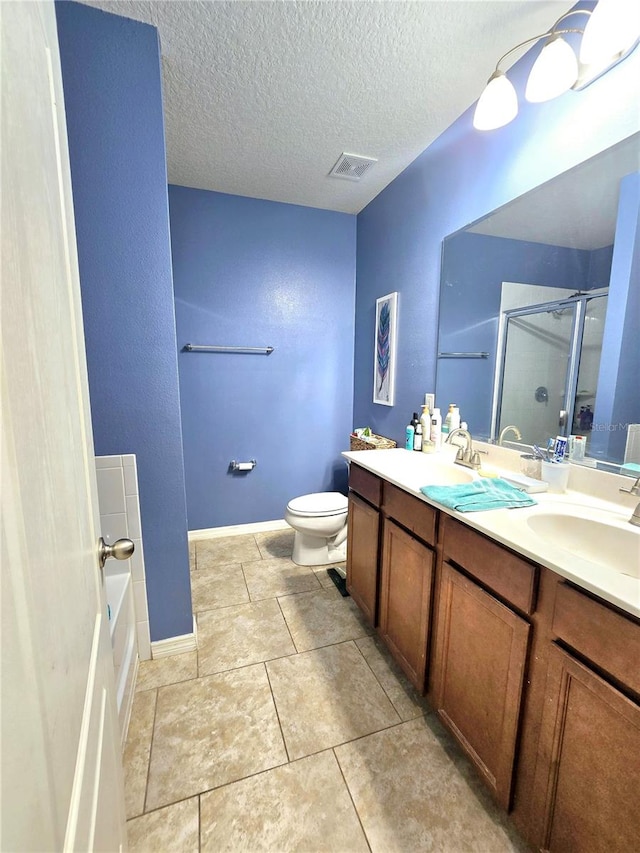 full bathroom featuring tile patterned flooring, separate shower and tub, vanity, a textured ceiling, and toilet