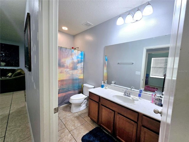 bathroom with tile patterned floors, toilet, a textured ceiling, vanity, and curtained shower