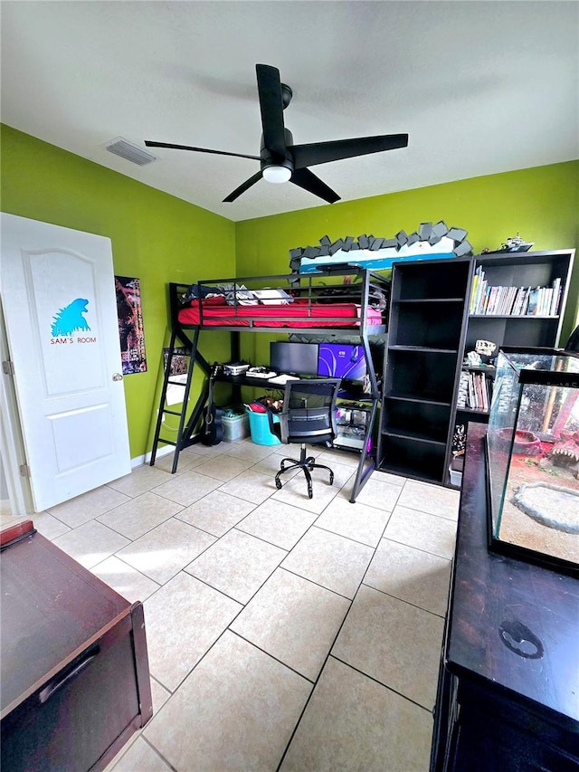 tiled bedroom featuring ceiling fan