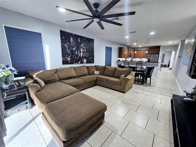 tiled living room with ceiling fan