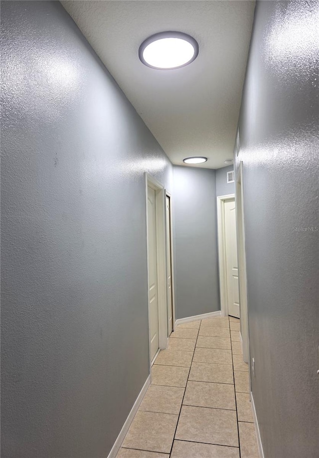 corridor with light tile patterned flooring