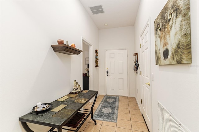 doorway to outside with light tile patterned floors