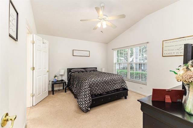 carpeted bedroom featuring lofted ceiling and ceiling fan