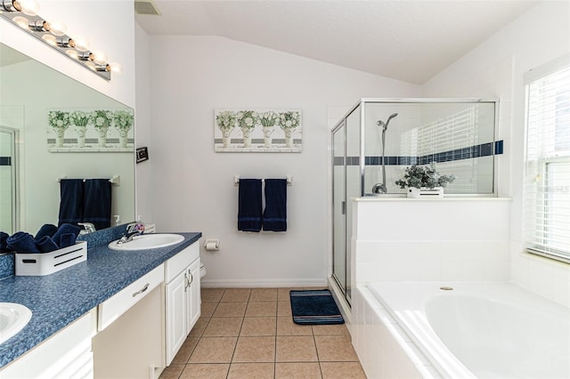 bathroom with vanity, lofted ceiling, a textured ceiling, plus walk in shower, and tile patterned floors