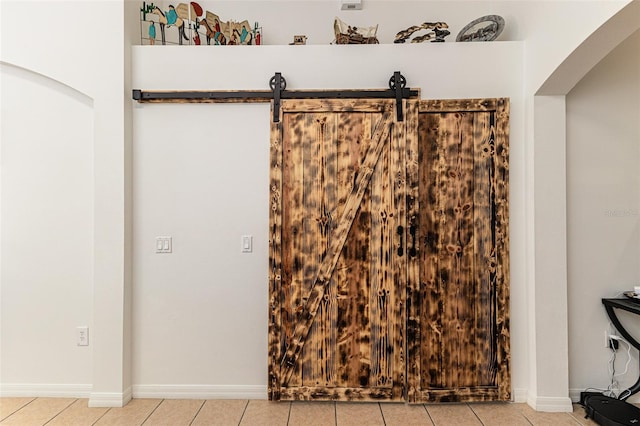 room details with a barn door and tile patterned flooring