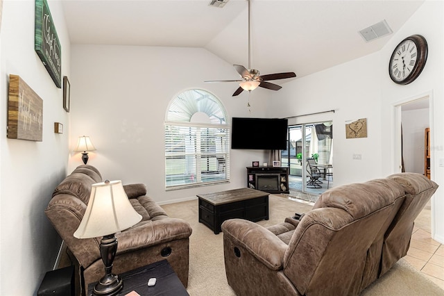 carpeted living room with ceiling fan, high vaulted ceiling, and a healthy amount of sunlight