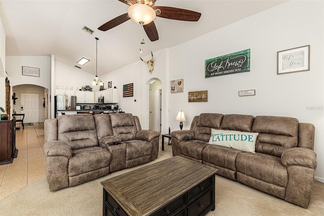 living room featuring ceiling fan, light tile patterned floors, and high vaulted ceiling