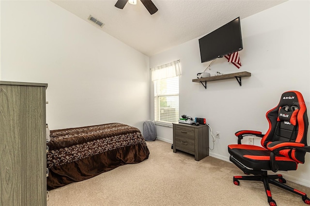 bedroom with vaulted ceiling, ceiling fan, and light colored carpet