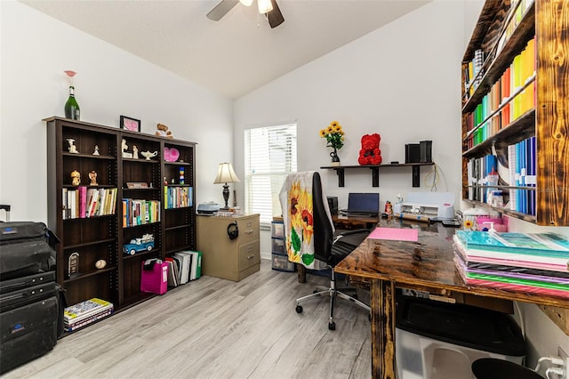 home office featuring ceiling fan, vaulted ceiling, and light hardwood / wood-style floors