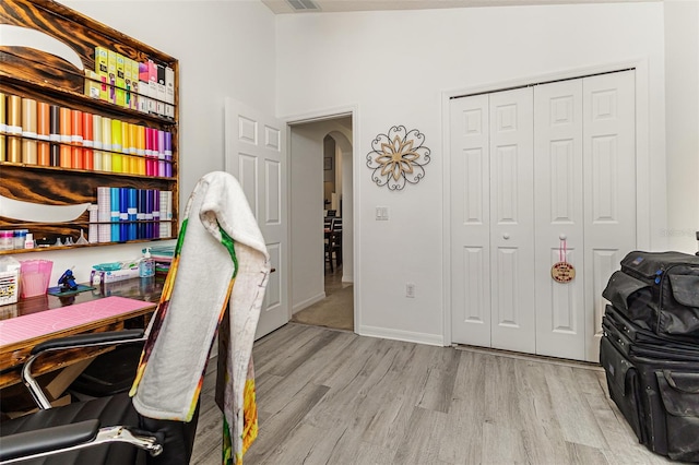 home office with light hardwood / wood-style flooring