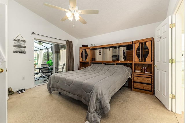 carpeted bedroom with access to outside, vaulted ceiling, and ceiling fan