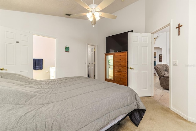 bedroom with ceiling fan, light colored carpet, a textured ceiling, and lofted ceiling