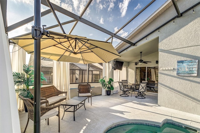 exterior space featuring ceiling fan and glass enclosure