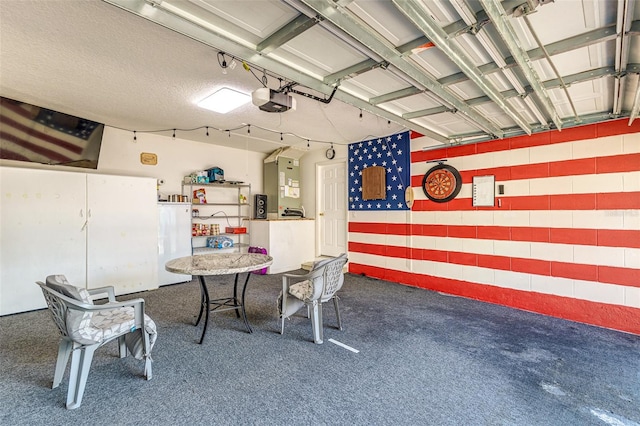 garage featuring a garage door opener and white refrigerator