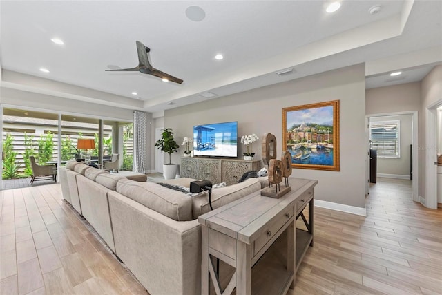 living room featuring ceiling fan and light hardwood / wood-style flooring