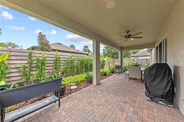 view of patio featuring ceiling fan and a grill