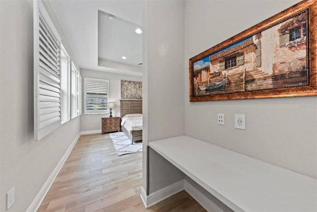 corridor with light hardwood / wood-style floors