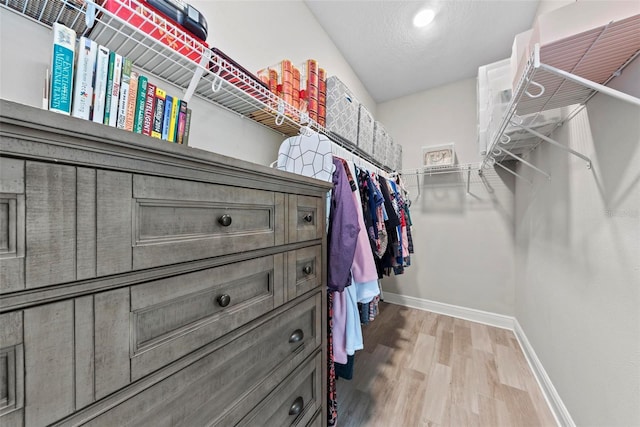 walk in closet with wood-type flooring