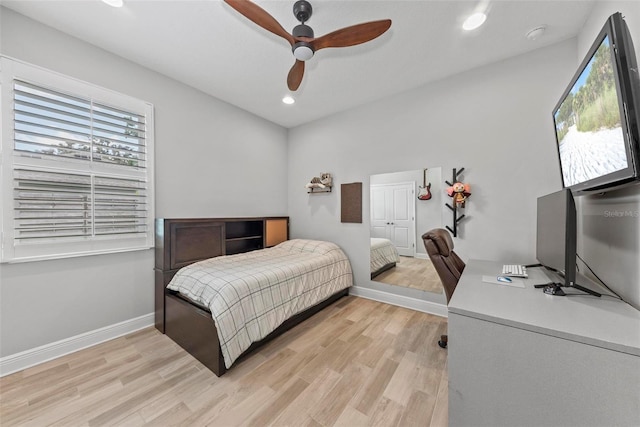 bedroom featuring multiple windows, light hardwood / wood-style floors, and ceiling fan