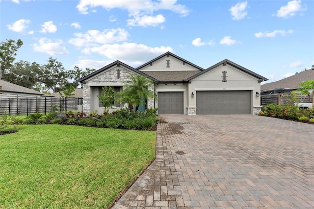 single story home featuring a garage and a front lawn