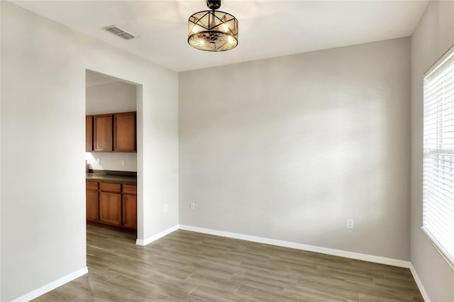 interior space with a notable chandelier and light wood-type flooring