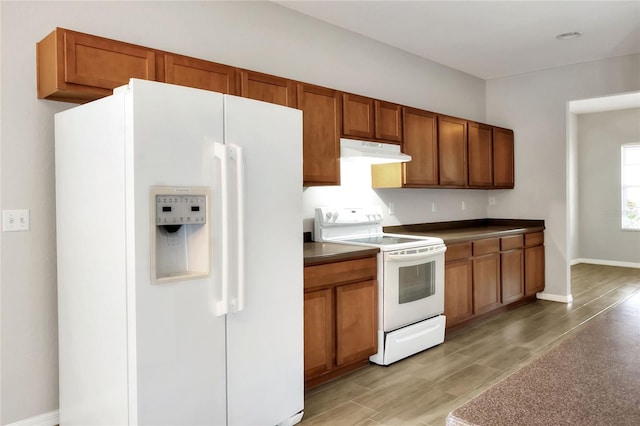 kitchen featuring light hardwood / wood-style floors and white appliances