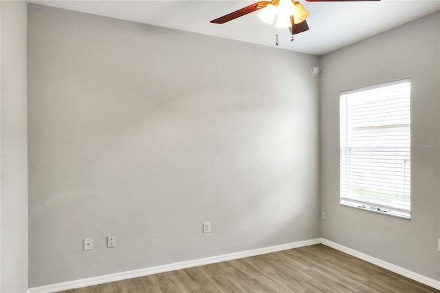 empty room with ceiling fan and hardwood / wood-style flooring