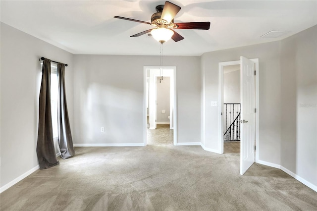 carpeted spare room with ceiling fan