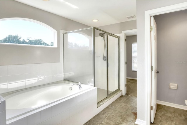 bathroom featuring separate shower and tub