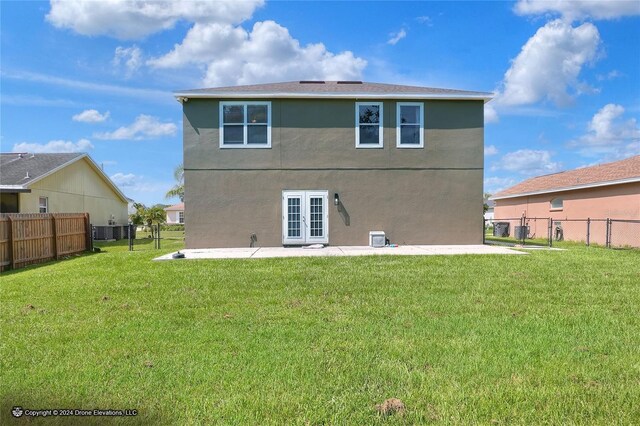 back of house with french doors, a yard, and a patio area