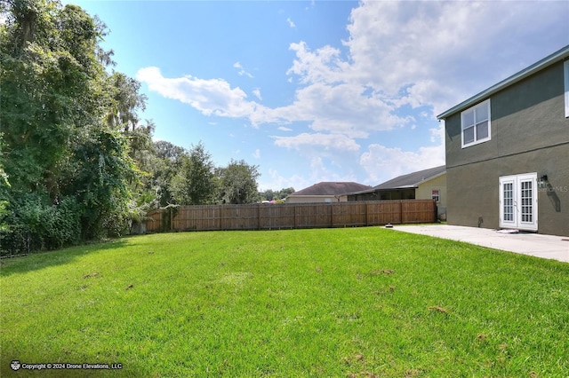 view of yard with a patio and french doors