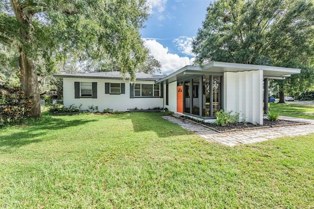 rear view of property featuring a yard