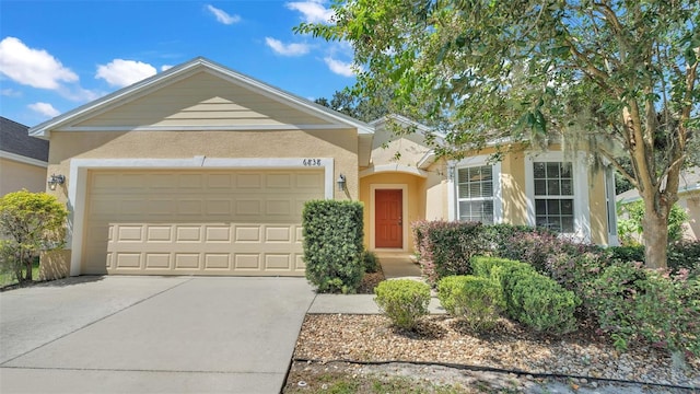 single story home with stucco siding, driveway, and an attached garage