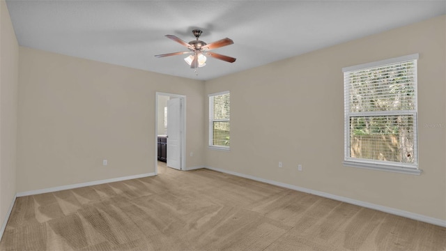 carpeted empty room featuring ceiling fan