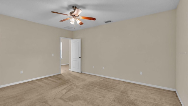 unfurnished room featuring light carpet and ceiling fan