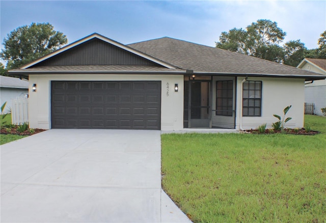 ranch-style home with a garage and a front lawn