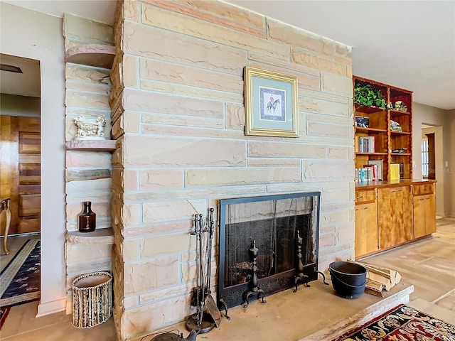 details with a stone fireplace and wood-type flooring