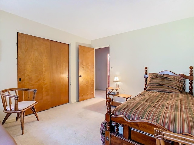 bedroom featuring light carpet and a closet