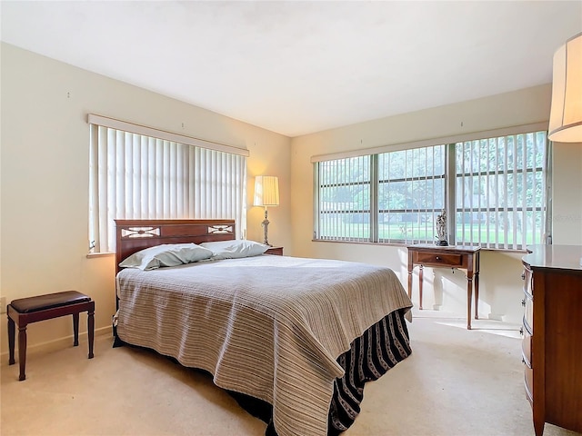 bedroom featuring light carpet