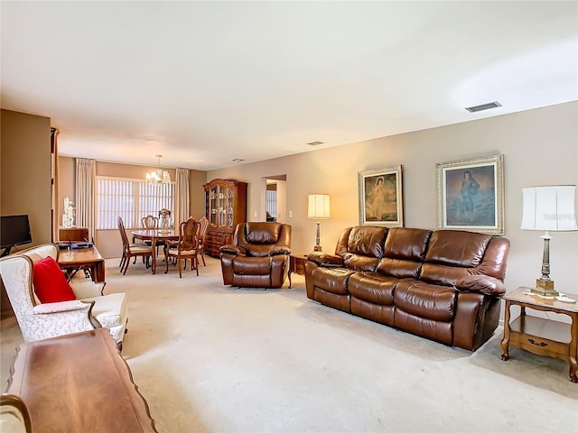 carpeted living room featuring a notable chandelier