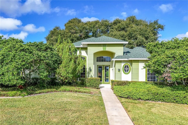 view of front of home with french doors and a front lawn