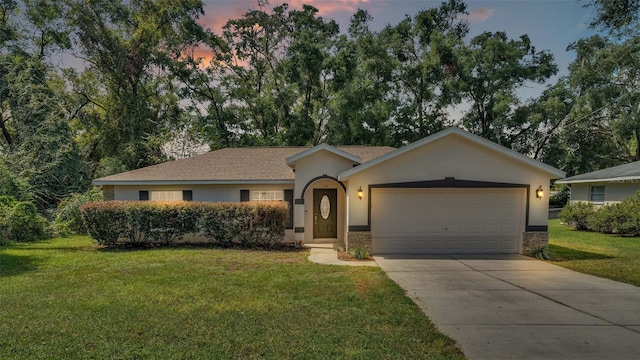 ranch-style house with a lawn and a garage