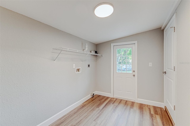 interior space with washer hookup, light hardwood / wood-style flooring, and hookup for an electric dryer