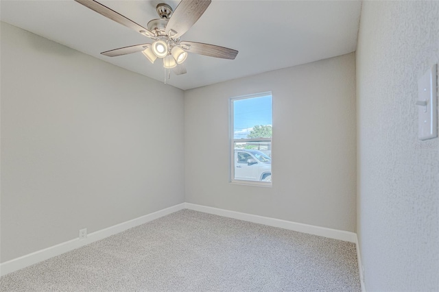 spare room with ceiling fan and carpet flooring