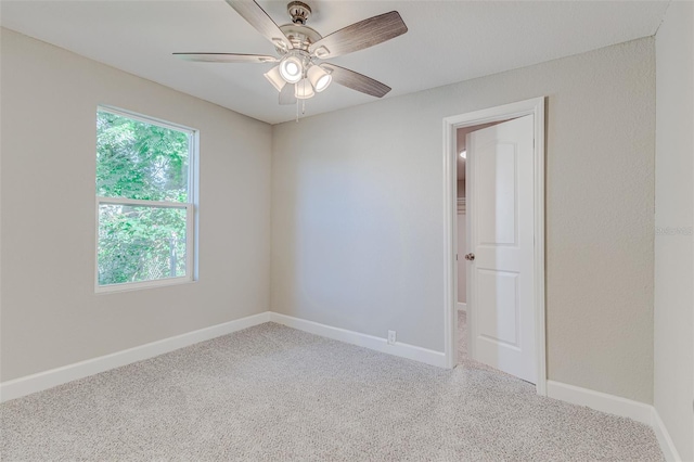 spare room with ceiling fan and carpet flooring