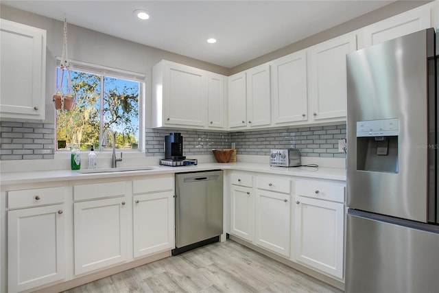 kitchen featuring white cabinets, stainless steel appliances, and sink