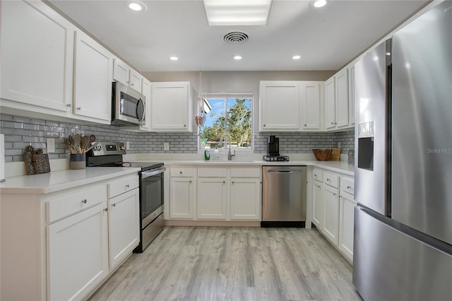 kitchen with white cabinetry, sink, and stainless steel appliances