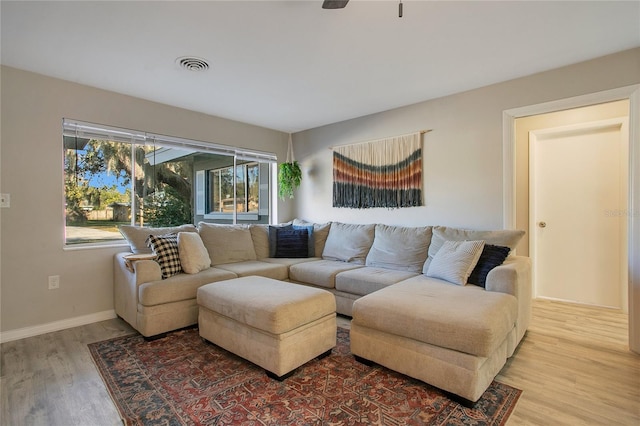 living room featuring hardwood / wood-style floors and ceiling fan