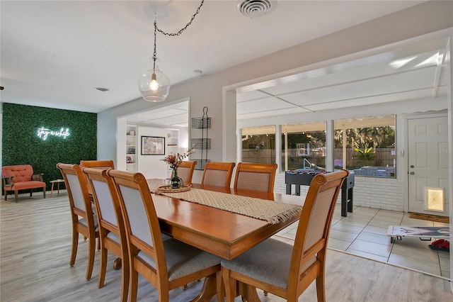 dining space with light hardwood / wood-style flooring